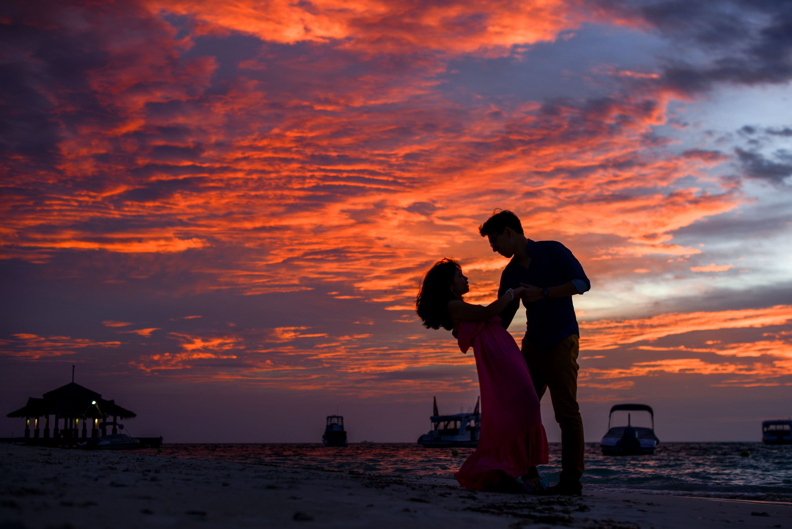 A couple silhouetted against an evening sky